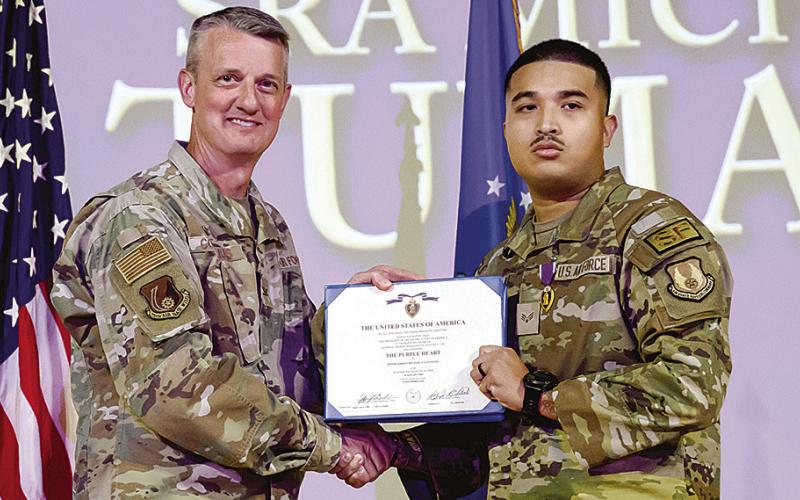 Right, Senior Airman Michael Tumang, 75th Security Forces Squadron, receives a Purple Heart from Col. Dan Cornelius, 75th Air Base Wing commander, during a ceremony April 30, 2026, at Hill Air Force Base, Utah.