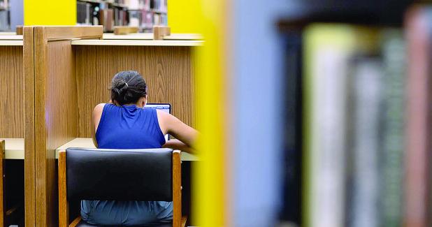 A student studies in the Perry-Castañeda Library on the UT Austin campus during finals week on April 28, 2025. Credit: Lorianne Willett/The Texas Tribune