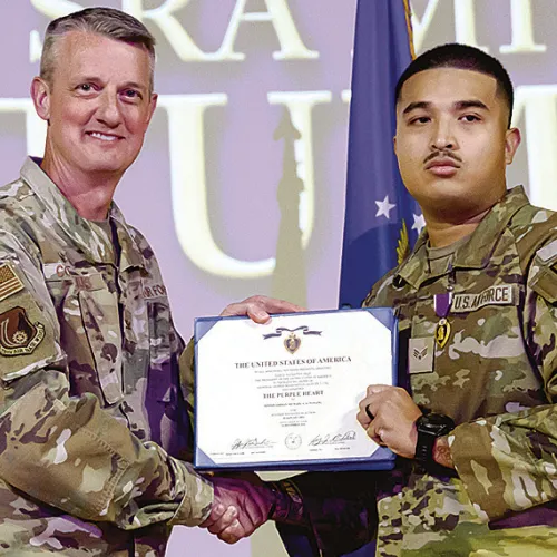 Right, Senior Airman Michael Tumang, 75th Security Forces Squadron, receives a Purple Heart from Col. Dan Cornelius, 75th Air Base Wing commander, during a ceremony April 30, 2026, at Hill Air Force Base, Utah.